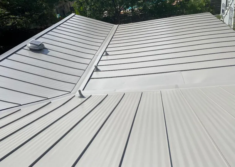 Solar attic fan installed on a metal roof for Roof Ventilation in Pine Castle